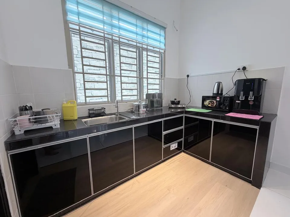 Fully equipped kitchen with countertop, stove, and modern cabinetry